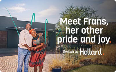 Hollard Building Insurance customer standing in front of her insured house, hugging her husband